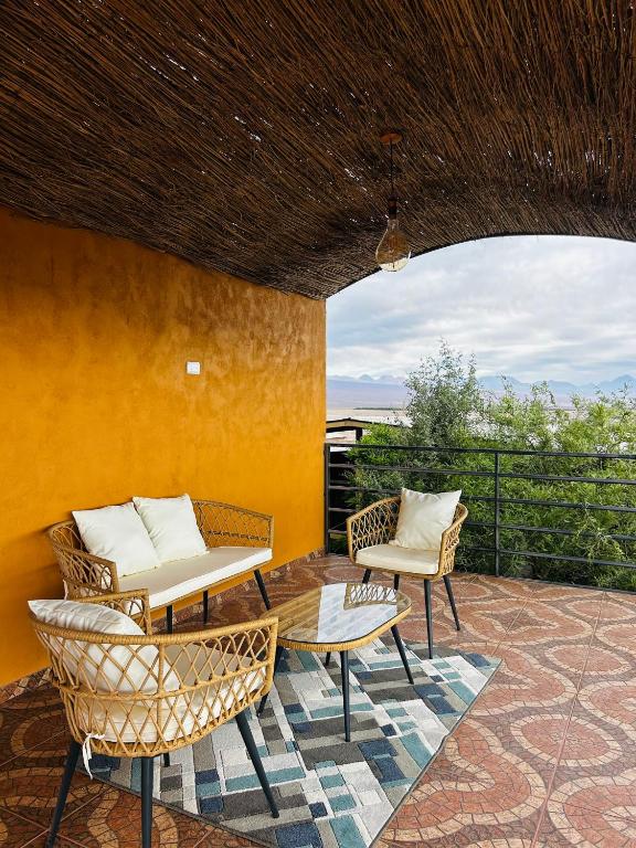 a patio with two chairs and a table at El Floramento in San Pedro de Atacama