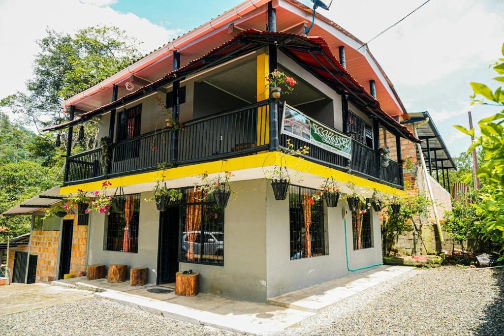 a yellow and white building with a balcony at Casa de Astilla in Mocoa