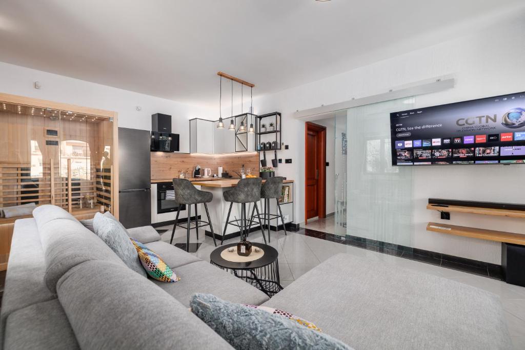 a living room with a couch and a bar at NOVA SPA - Sauna Suite for Two in Rijeka