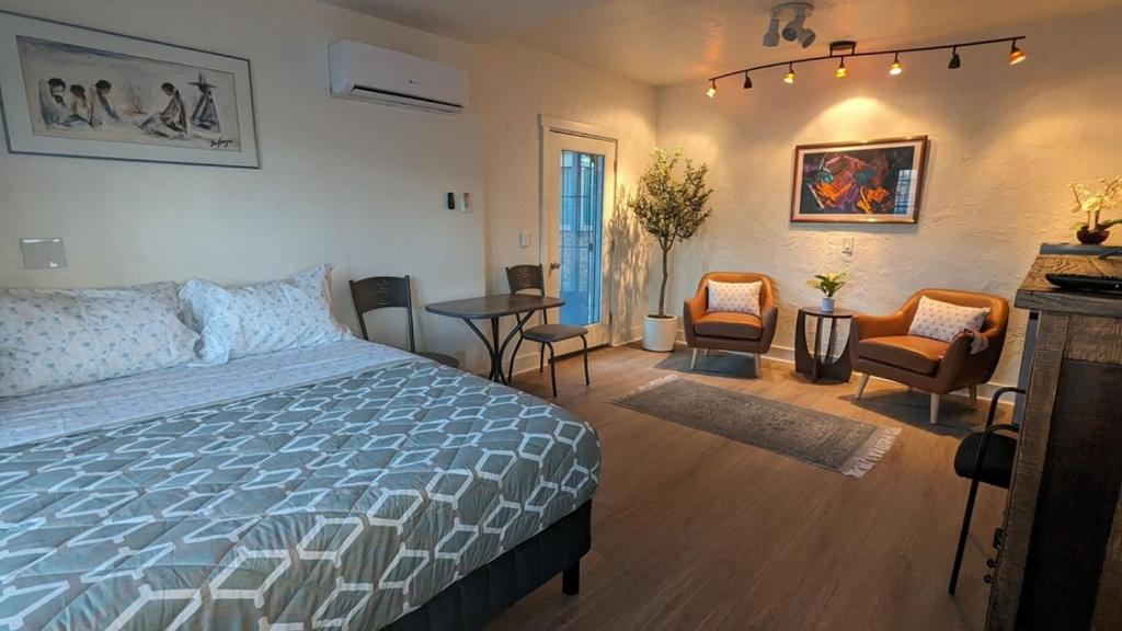 a bedroom with a bed and a table and chairs at Studio Speedway in Tucson