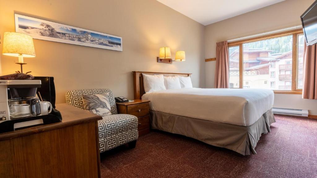 a hotel room with a bed and a window at Cahilty #108 home in Sun Peaks