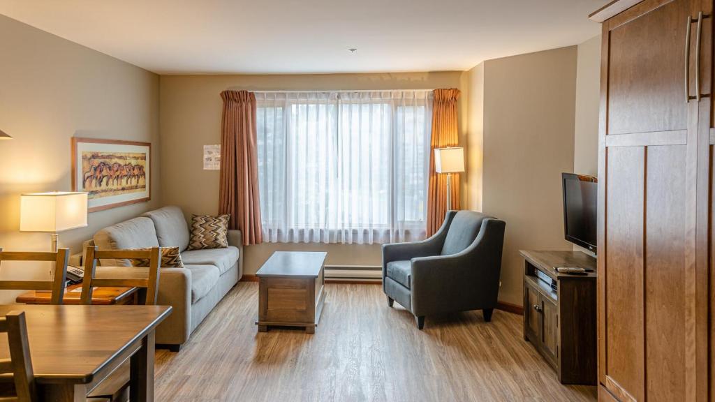 a living room with a couch and a tv at Cahilty #214 home in Sun Peaks