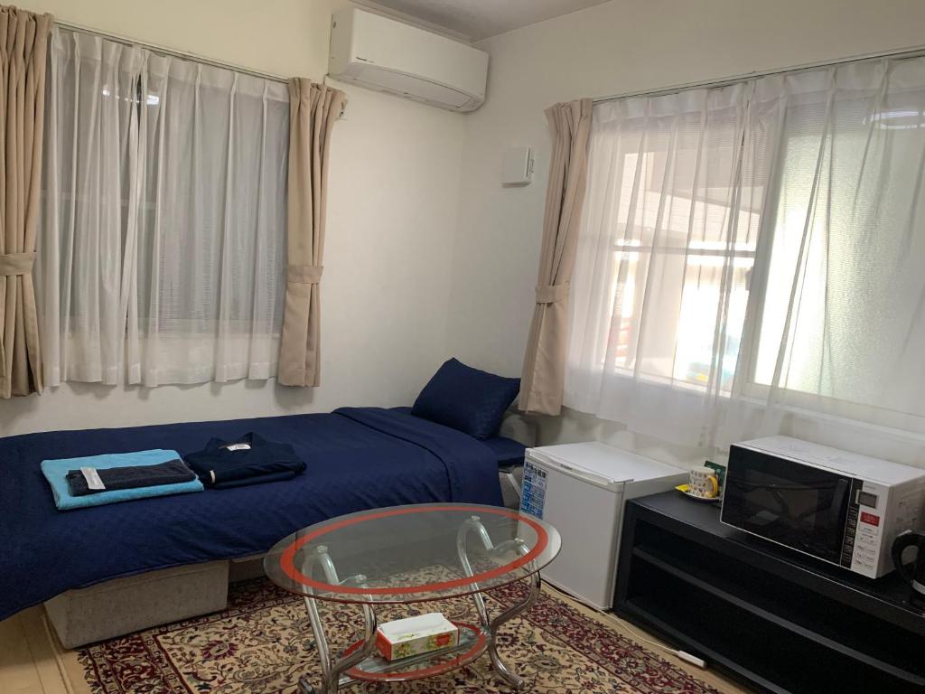a small room with a bed and a tv at Bessalov Home 2nd room friendly house in Tokyo