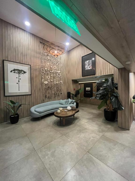 a living room with a couch and a table at Exclusivo departamento in Valdivia