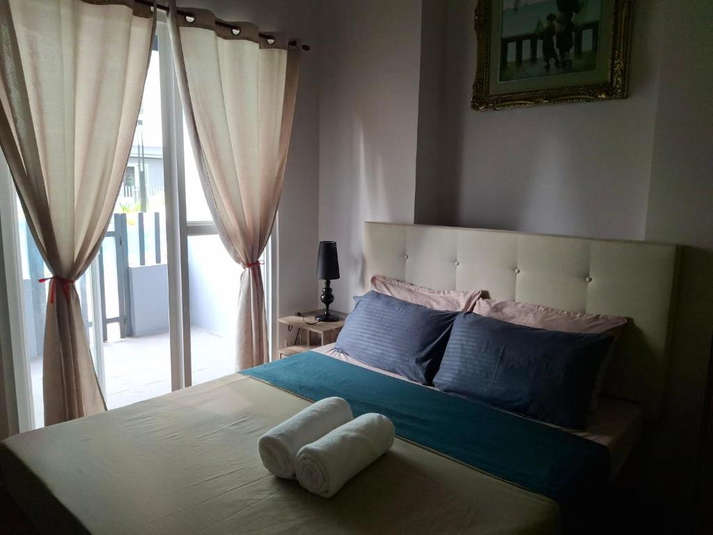 a bedroom with a bed with two pillows on it at Casa Aurora Mandaue Cebu in Sampong