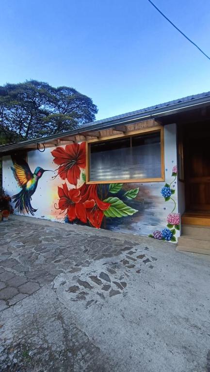 a building with a mural of a bird on it at La Casa de Martin in Baños