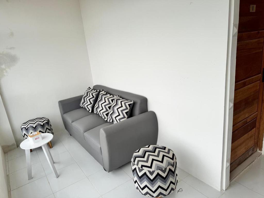 a living room with a couch and a table at G-House-2 in Singkawang