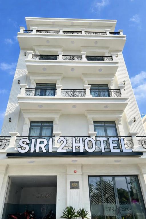 a white building with a sign on it at Siri 2 Hotel in Mỹ Tho