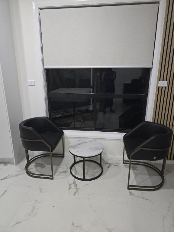 two chairs and a table in front of a window at Simran's in Glenwood