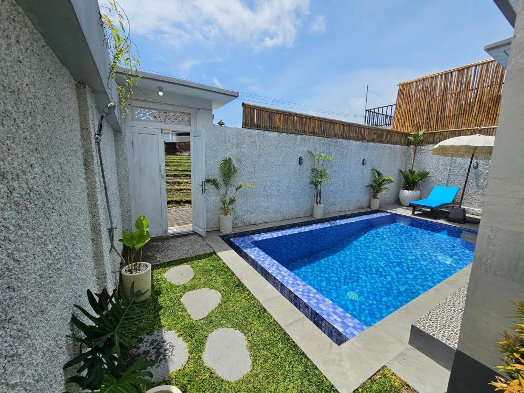 a swimming pool in the backyard of a house at Villa Casa Delta Canggu in Canggu