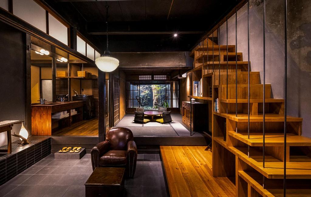a living room with a spiral staircase in a room at Rinn Kyoto Imperial Palace South Kishoan in Kyoto