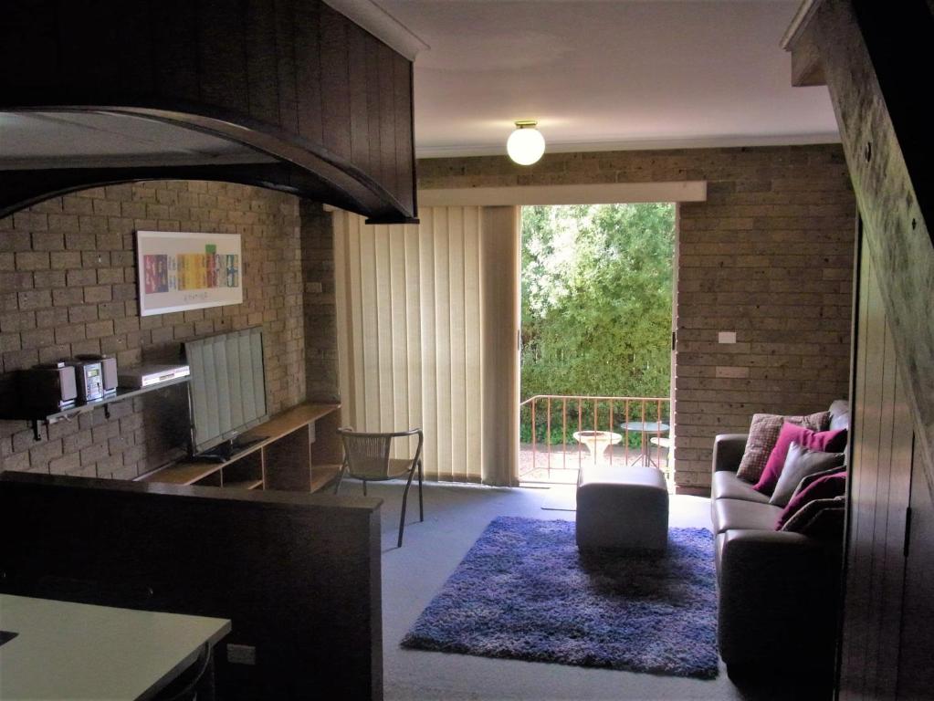 un soggiorno con divano e tavolo di A Furnished Townhouse in Goulburn a Goulburn