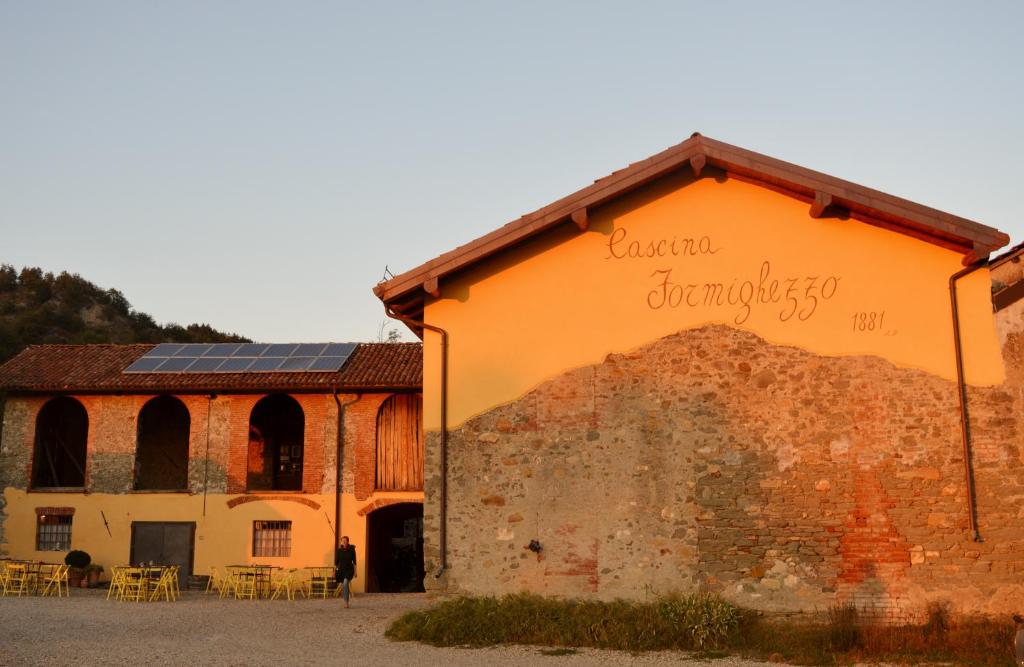 an orange building with a sign on the side of it at Cascina Formighezzo in Arquata Scrivia