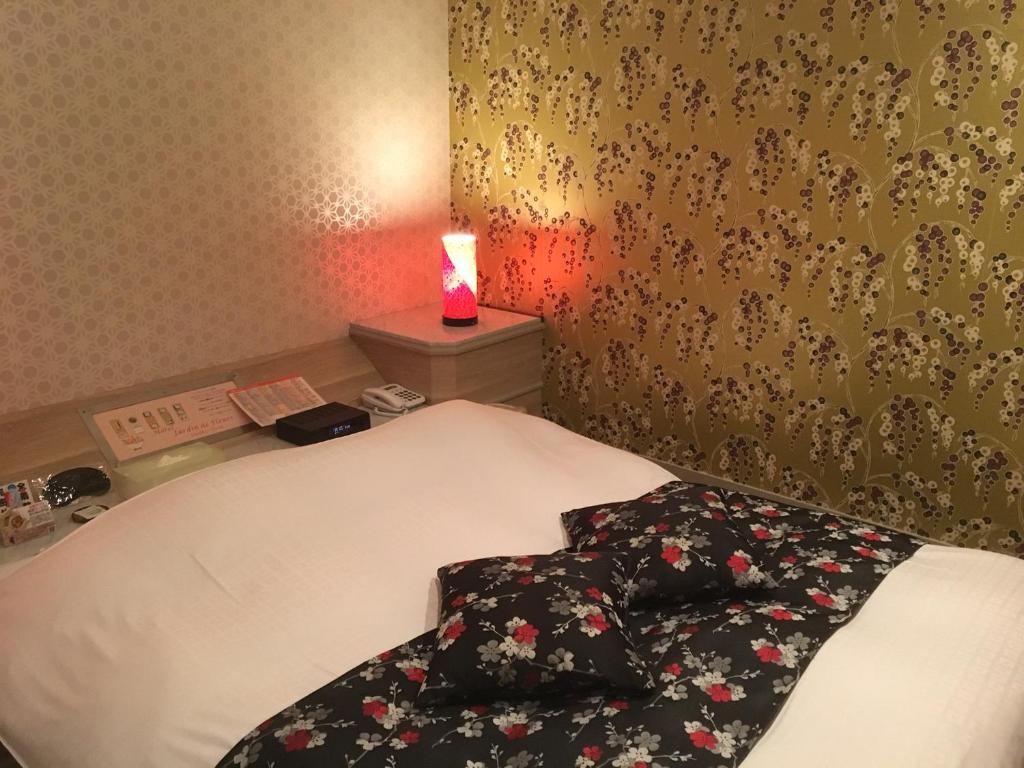 Postel nebo postele na pokoji v ubytování Hotel Jardin de Fleurs (Adult Only)