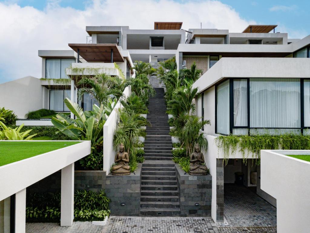 a house with stairs in front of it at Kono Villas & Resort in Ungasan