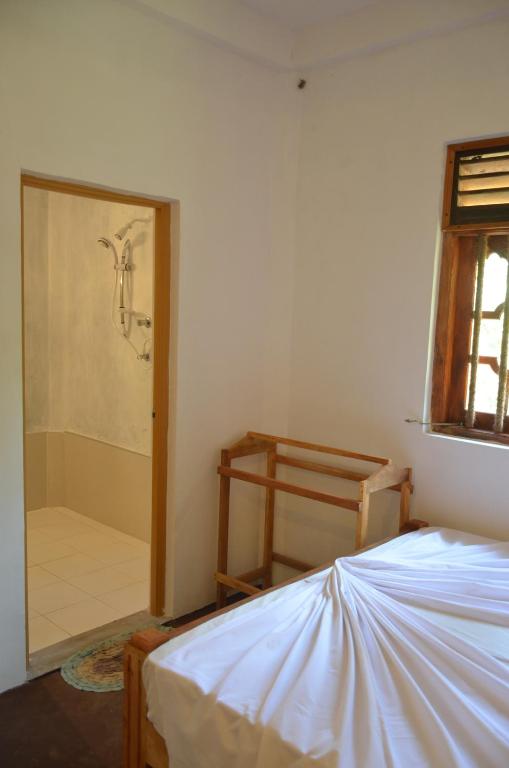 Postel nebo postele na pokoji v ubytování Yaye Guest House