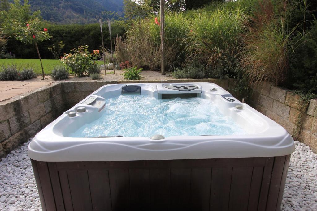 a jacuzzi tub in a garden at Villa Montelago in Rottach-Egern