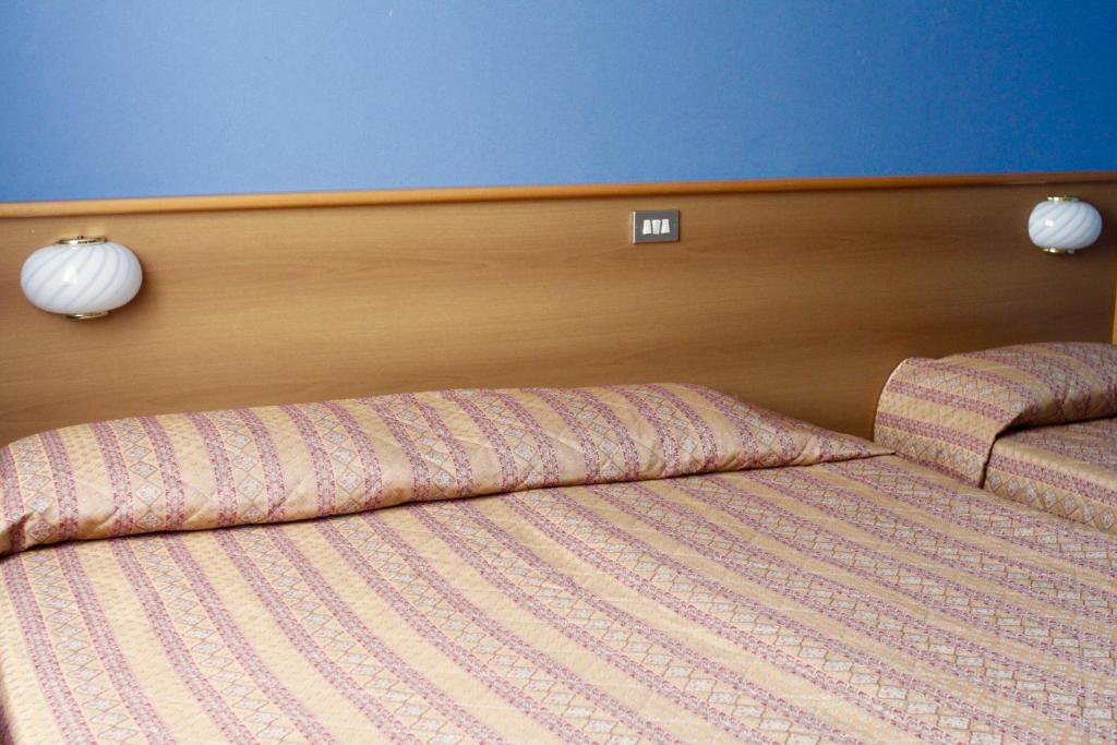 Postel nebo postele na pokoji v ubytování Hotel Monumento
