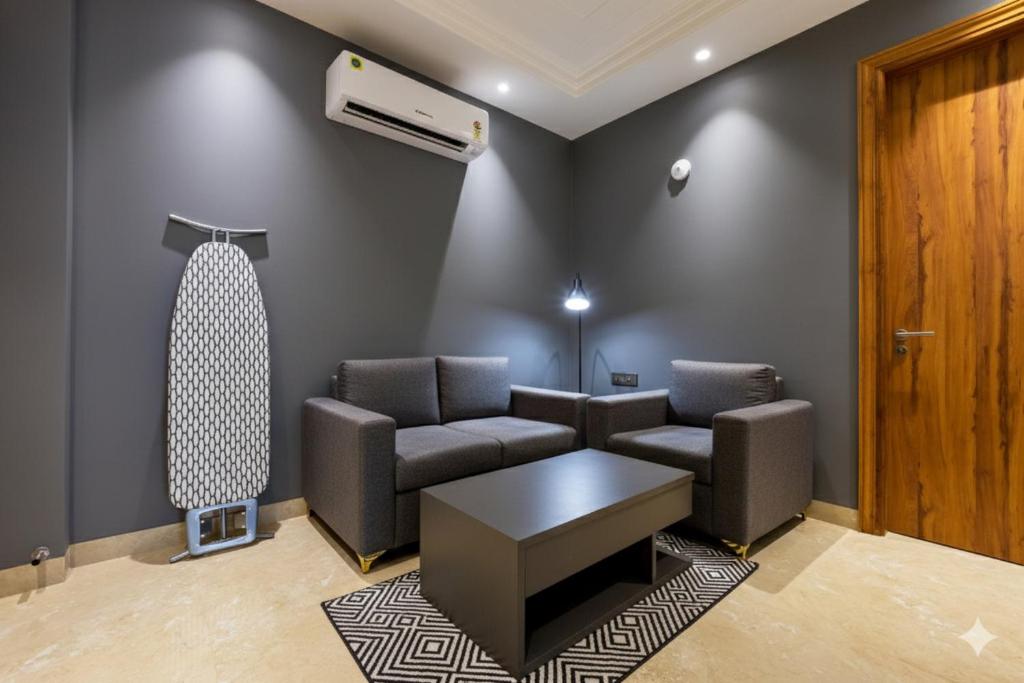 a living room with a couch and a table at Hotel Xotic Avenue in Gurgaon