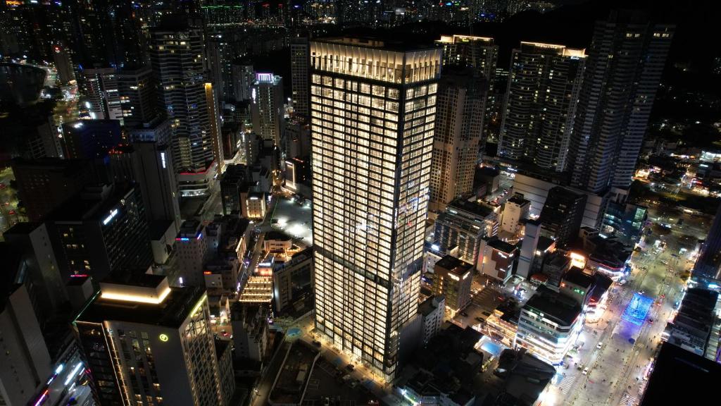 a tall building in a city at night at Palatium Haeundae by SONO Felice in Busan