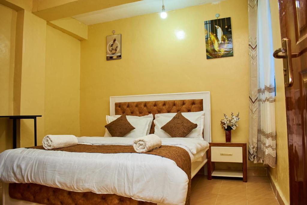 a bedroom with two beds with towels on them at Kajole Homestay in Kakamega