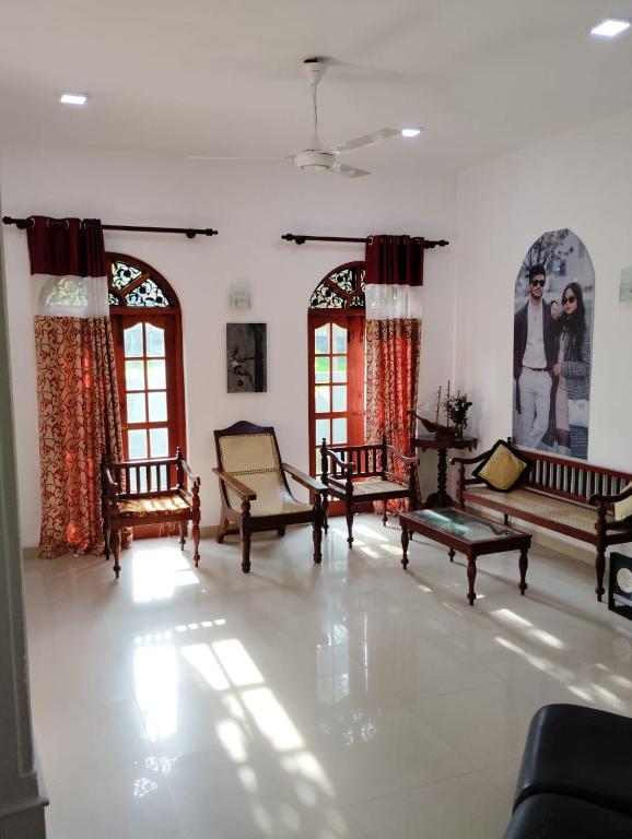 a living room with couches and tables in it at Green View in Ambalangoda