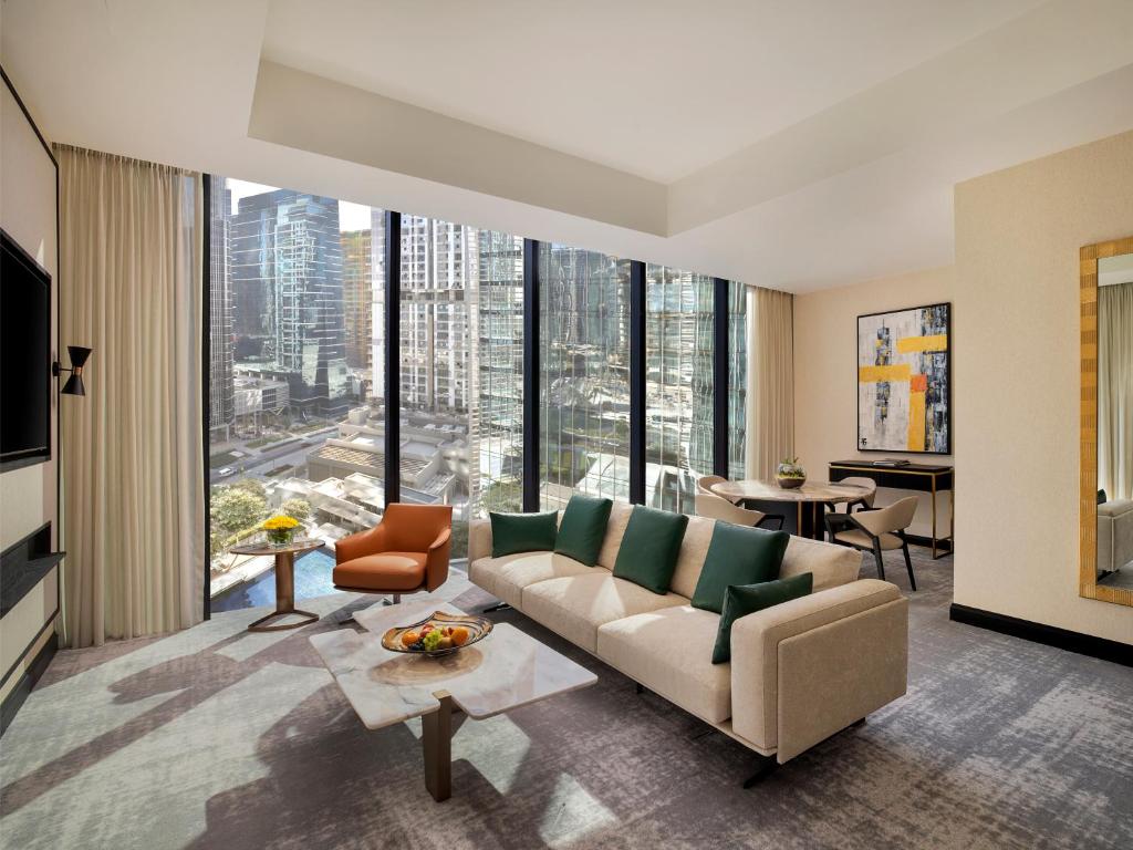 a living room with a couch and a large window at Anantara Downtown Dubai in Dubai