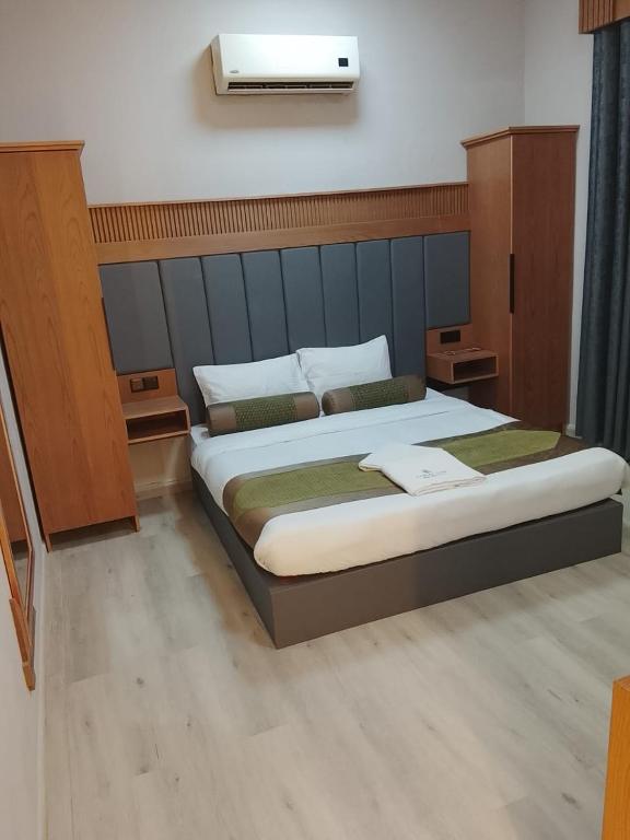 a bedroom with a large bed in a room at Coral Bay King Studio in Khor Fakkan