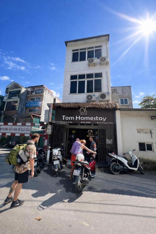 a group of people on motorcycles in front of a store at Tom Homestay Cao Bang - Motorbike rental in Cao Bằng