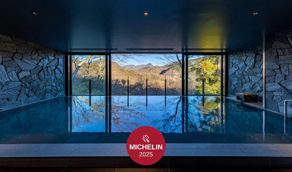 a room with a large window with a view of a lake at Fufu Hakone in Hakone