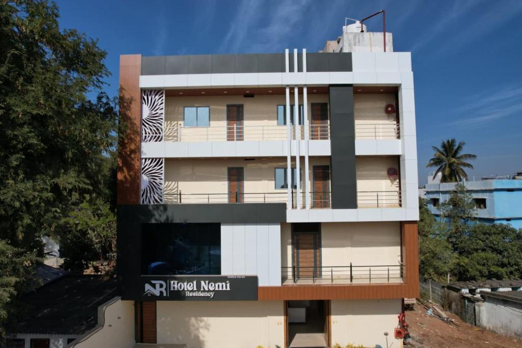 a building with a sign on the side of it at hotel NemiResidency in Jagdalpur