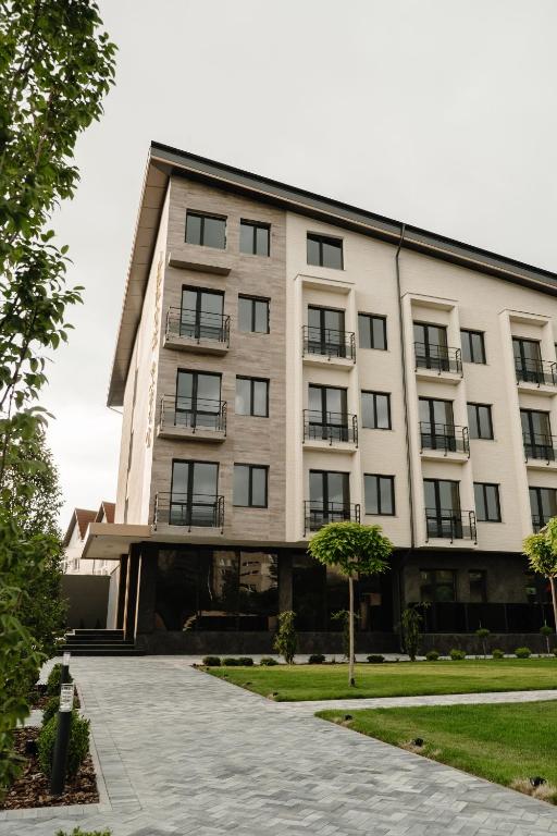 a large white building with balconies on it at Hotel Oasis in Vinnytsya