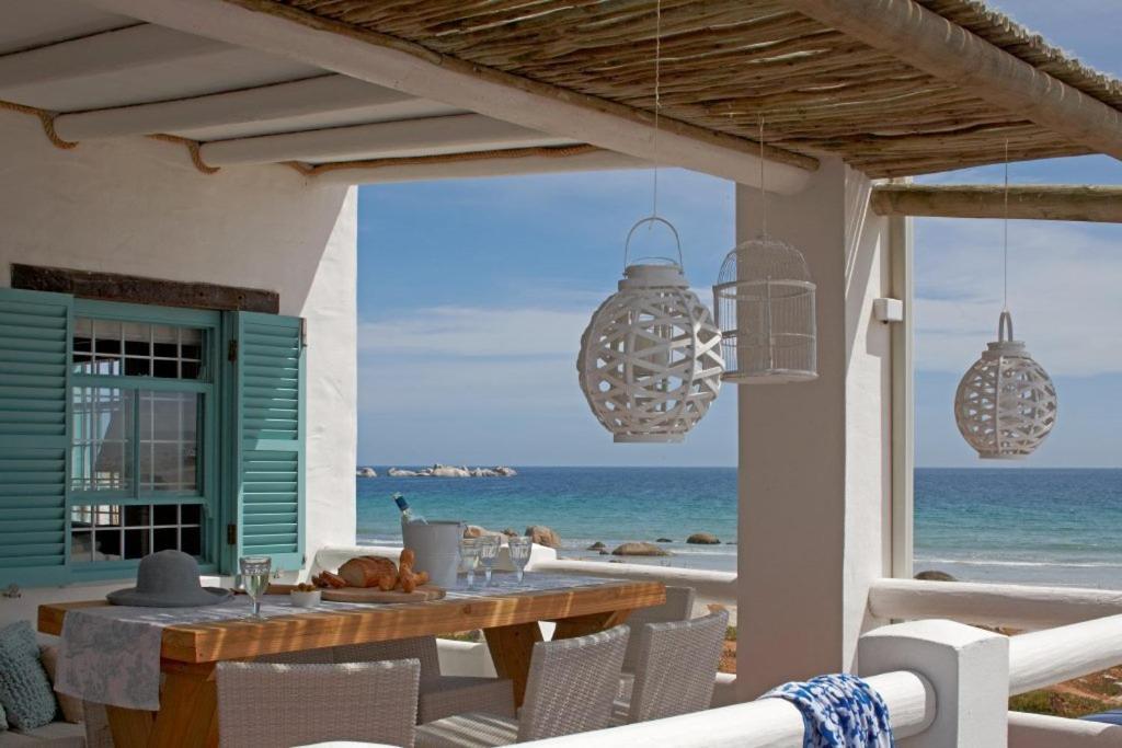 mesa de comedor en la playa con vistas al océano en Dankbaar Holiday Home, en Paternoster