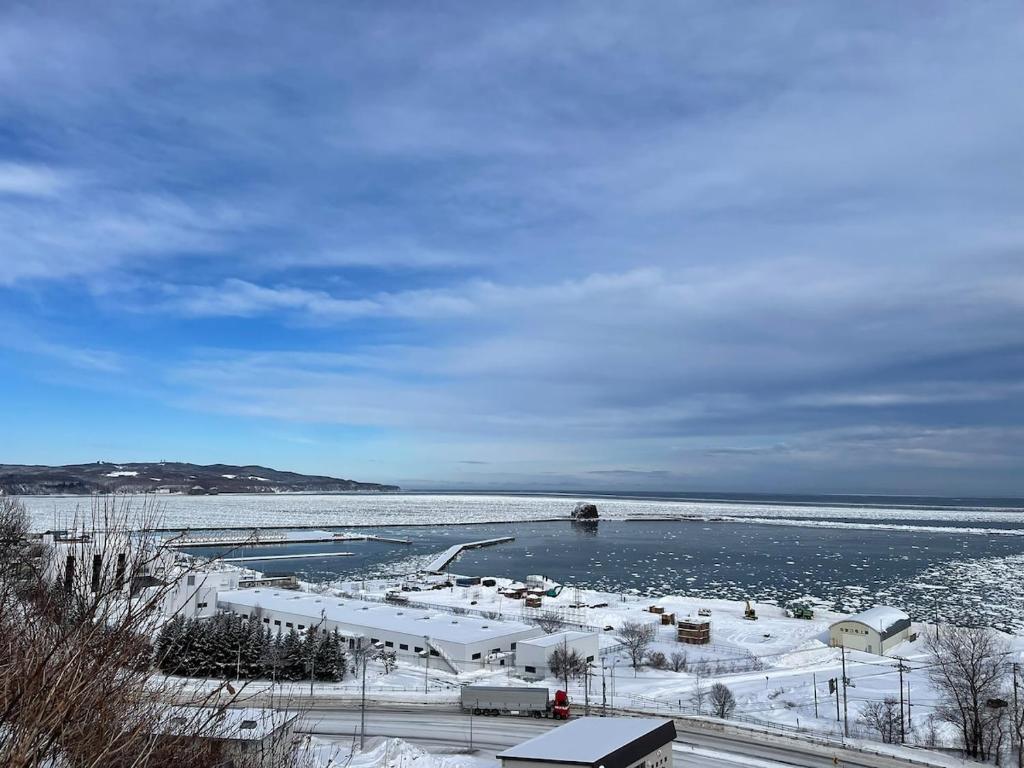 a large body of water with snow on the ground at 台町Arun別邸 in Abashiri