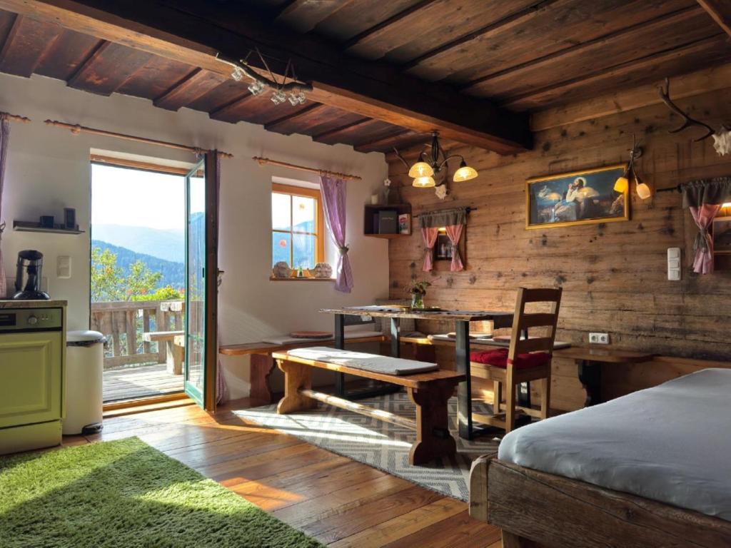 a bedroom with a table and a dining room at Ottls Huette in Sankt Lorenzen ob Murau