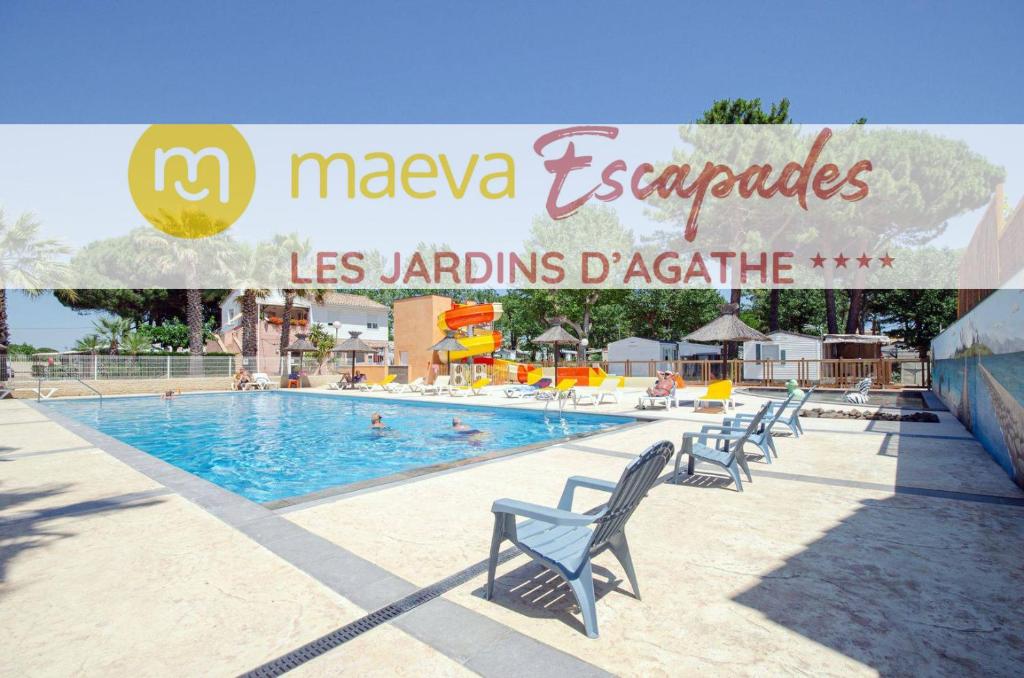 a pool in a resort with chairs around it at Camping Les Jardins d Agathe in Le Grau-dʼAgde