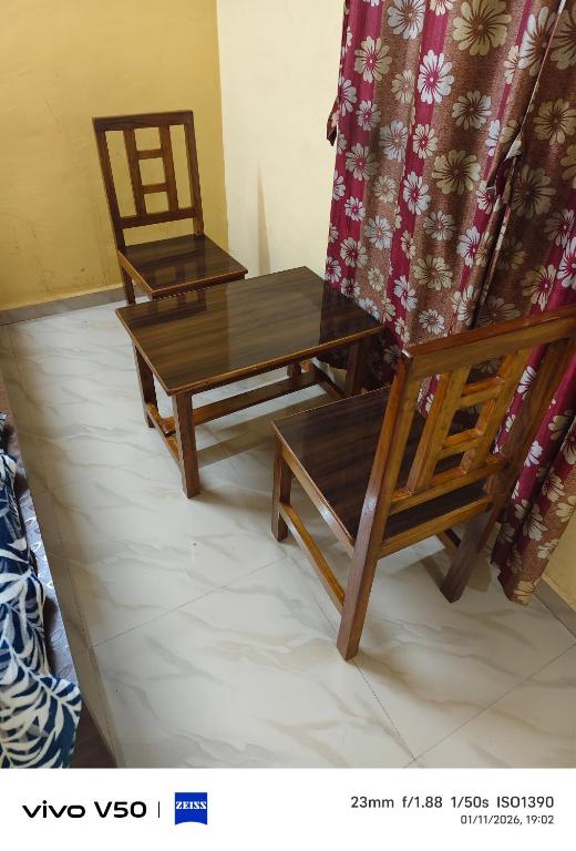 two chairs and a table in a room at Kadaiya house in Marwad