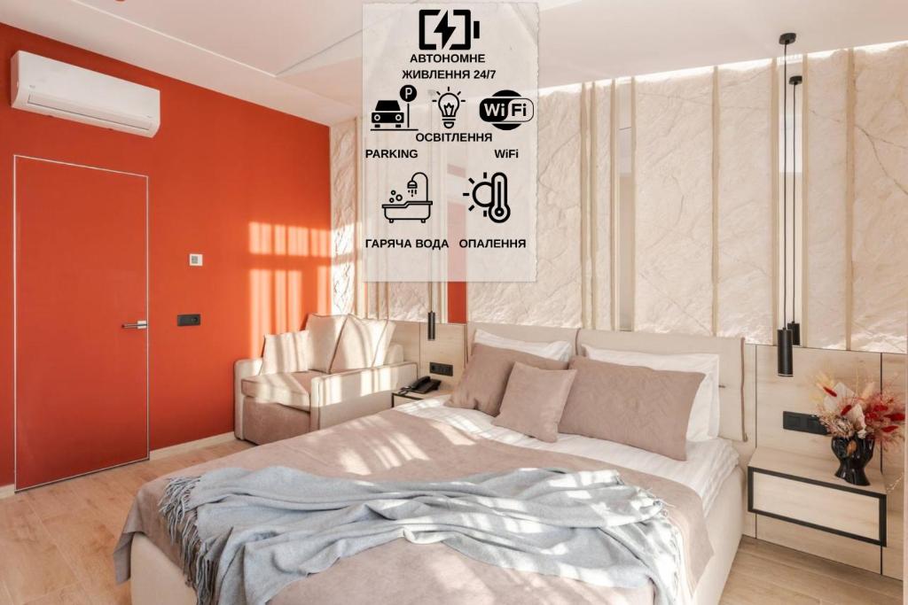 a bedroom with a large white bed and a chair at ACCENT Apart-Hotel in Lviv
