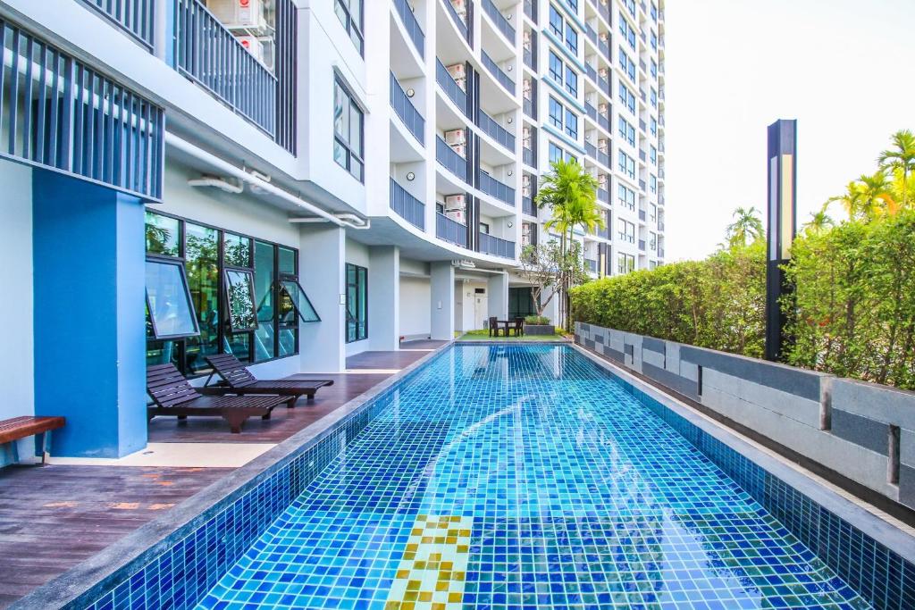 a swimming pool in the middle of a building at Vista Residence Old Town in Phuket