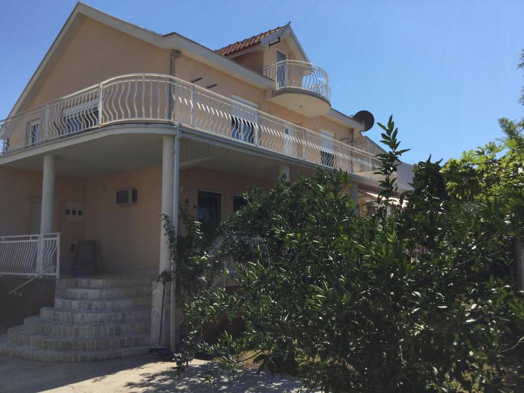 a house with a balcony on top of it at Apartment Dorada in Dobra Voda