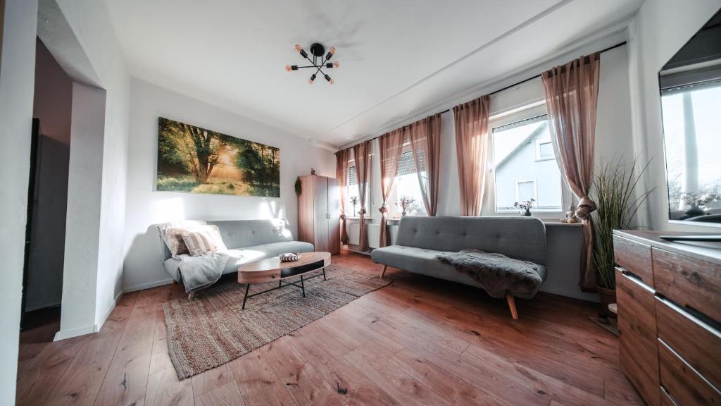 a living room with a couch and a table at FlexHome Stilvolle Ferienwohnung in Lippstadt