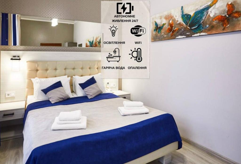 a bedroom with a bed with towels on it at ANTARES Apart hotel in Lviv