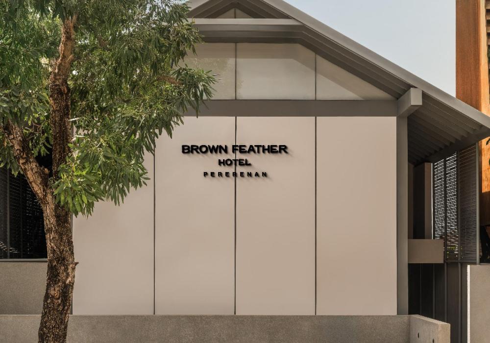 a building with a sign on the side of it at Brown Feather Pererenan in Canggu