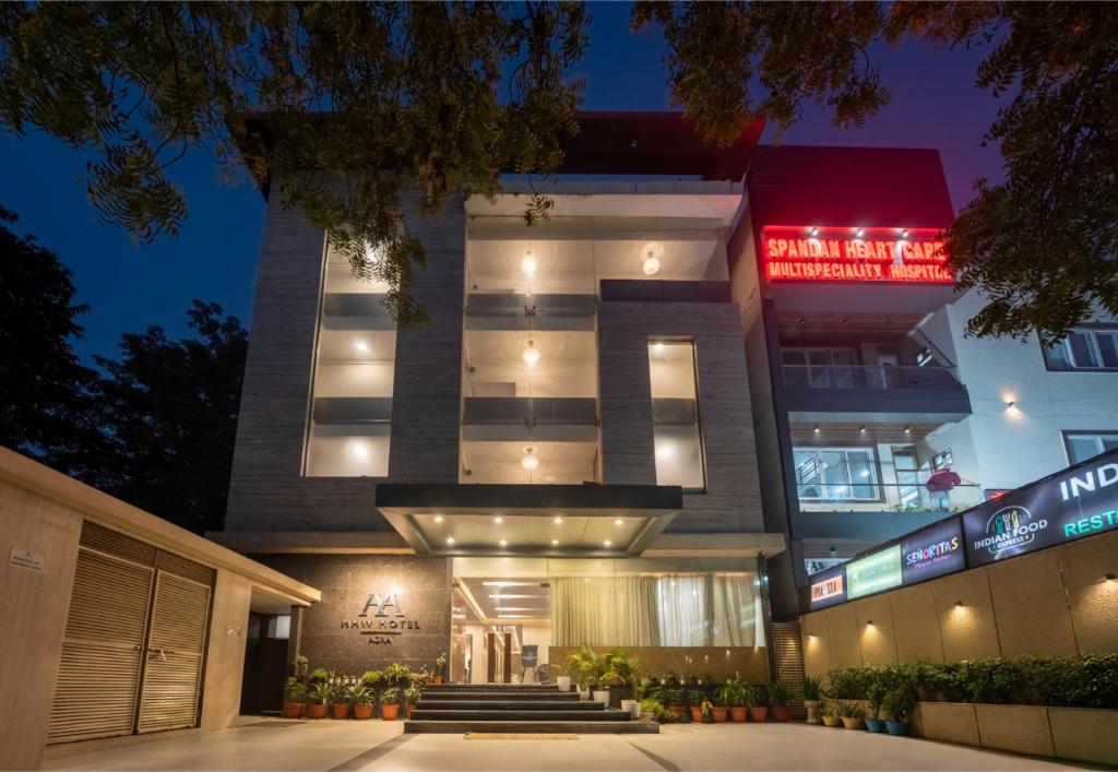a hotel building with a lit up sign at night at HHW Hotel- Agra in Agra