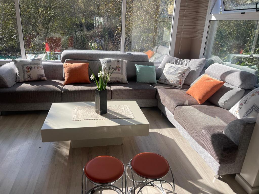 a living room with a couch and a table and chairs at "Chez Maria" in Stroumbi