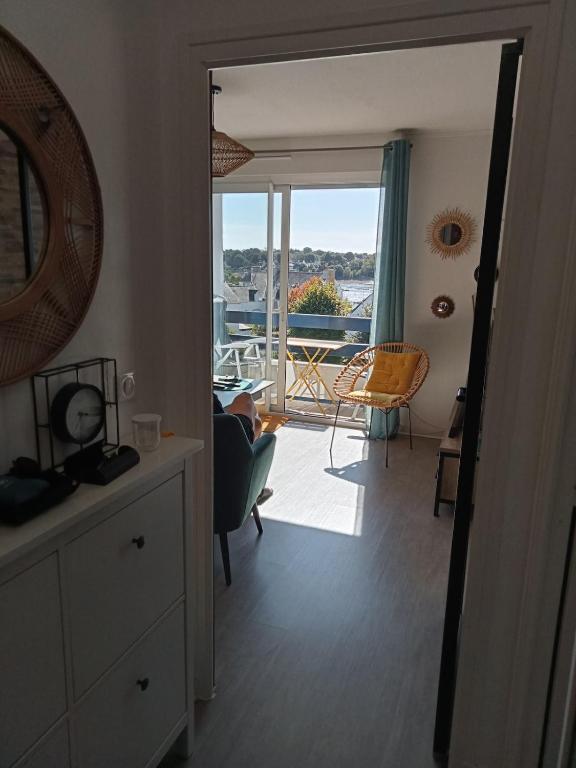a living room with a view of a balcony at les vagues a Bénodet in Bénodet