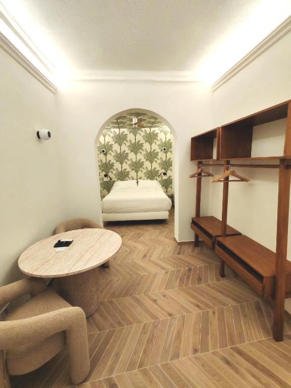 a living room with a table and a bed at Il Caruggio Townhouse in Varazze