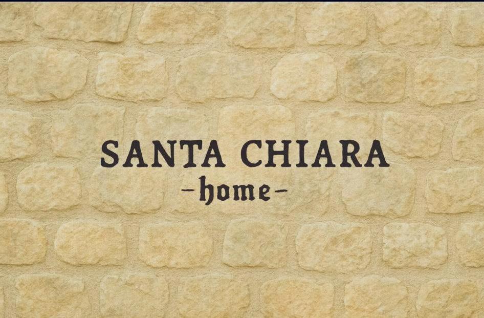 a sign that says santa clara on a brick wall at B&B Santa Chiara Home in Caserta