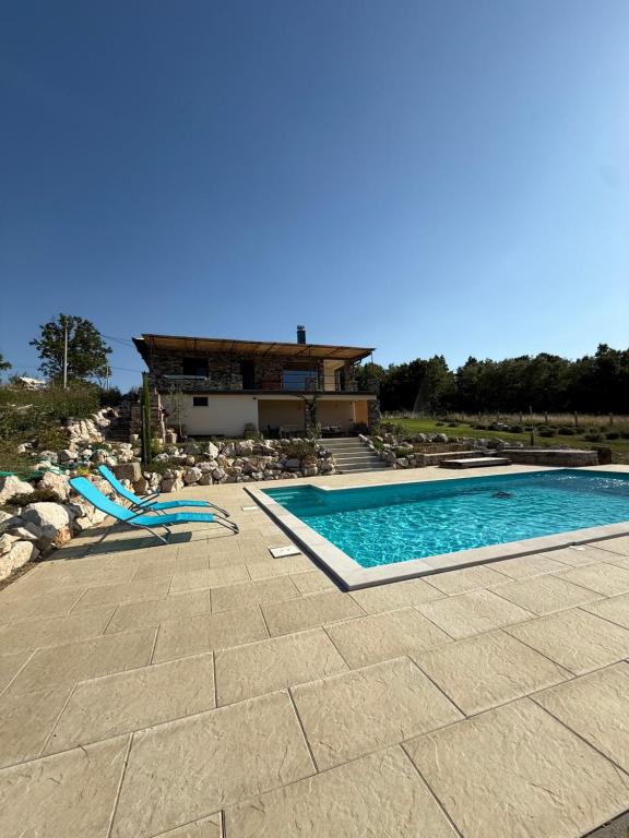 a swimming pool in front of a house at Casa Elena in Banja Luka