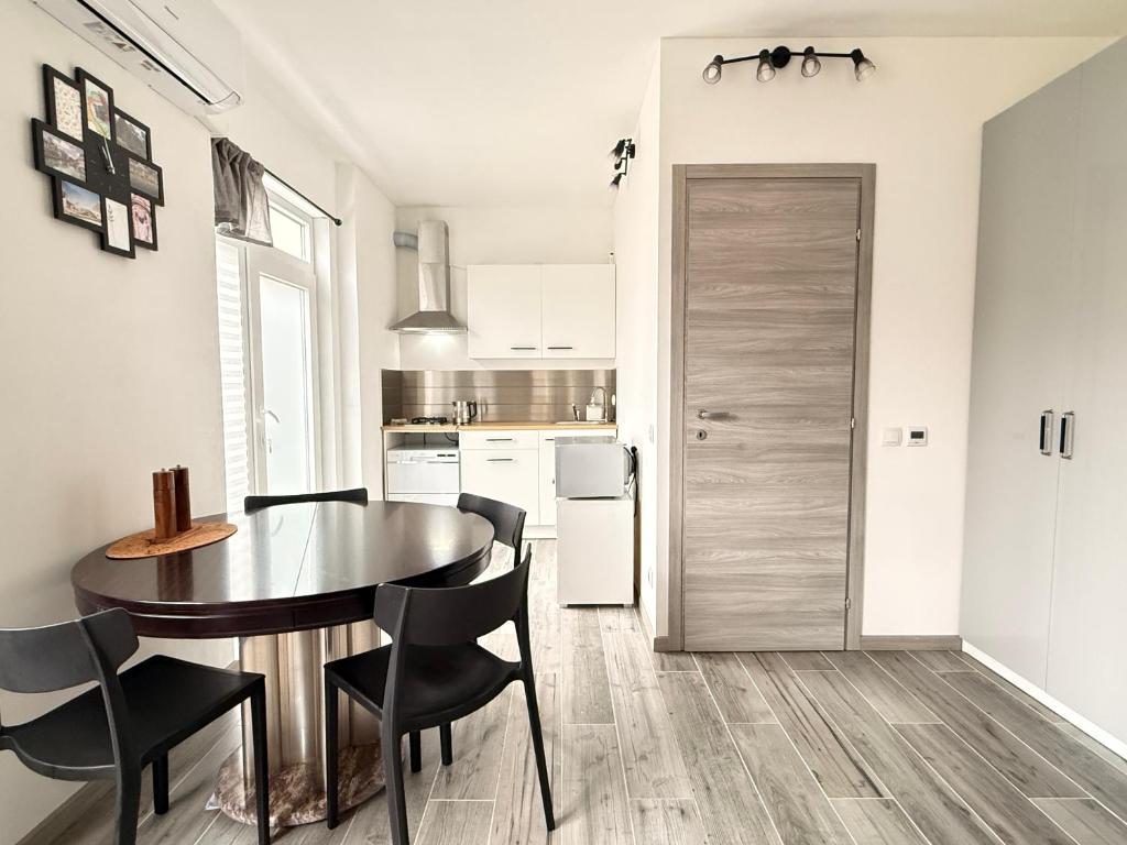 a kitchen and dining room with a table and chairs at Casa Buda 1BR Apartment - Lakes Malpensa MXP 24h Check-in Parking in Sesto Calende